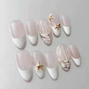 Close-up of 3D shell accent on nude almond nail with white French tip and painted starfish