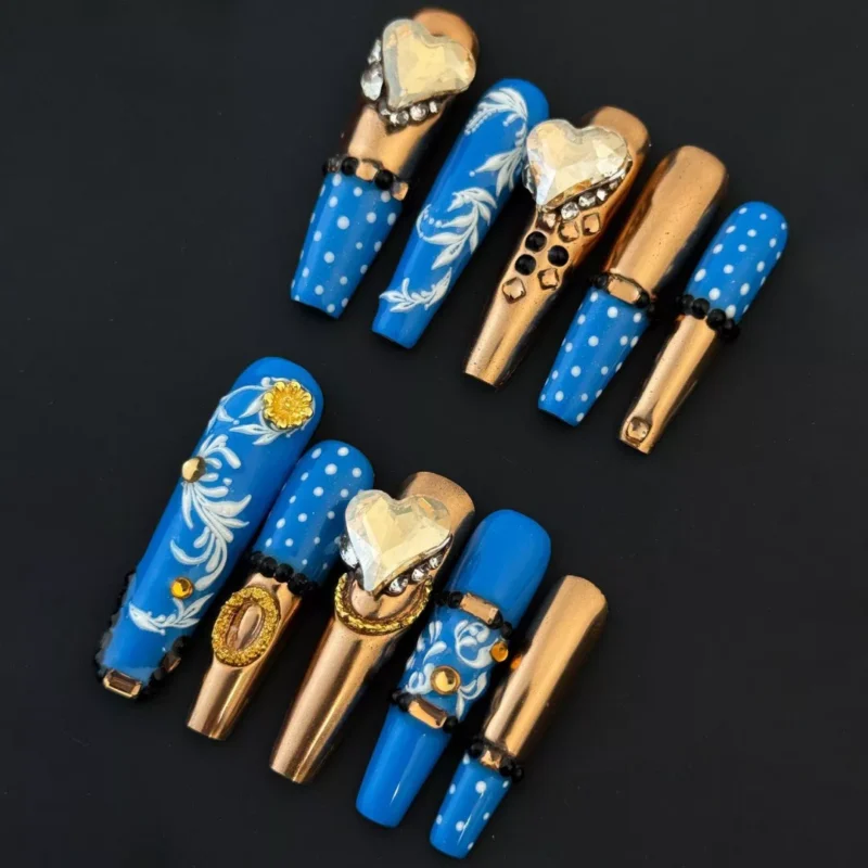 Side view of Royal Blue Press-On Nails with shimmering gold accents and crystal hearts