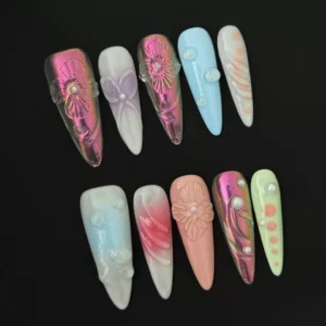 Side angle of pastel press-on nails with mixed 3D textures including flower, bubble, and pearl