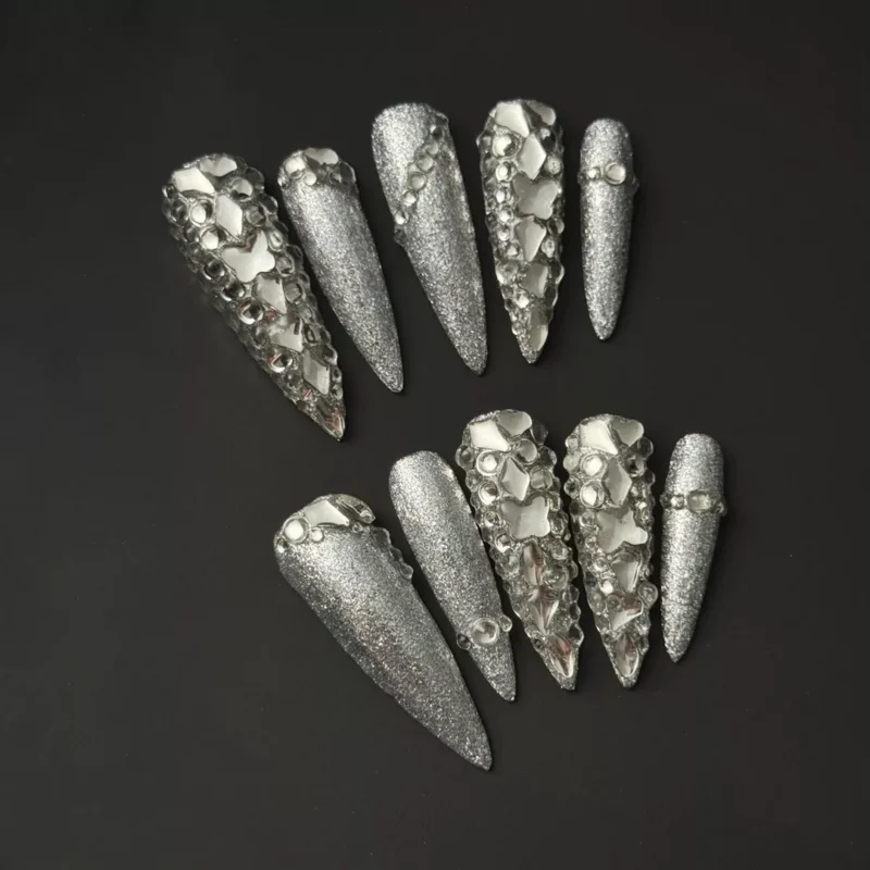 Silver Diamond press-on nails with stiletto shape and rhinestone clusters