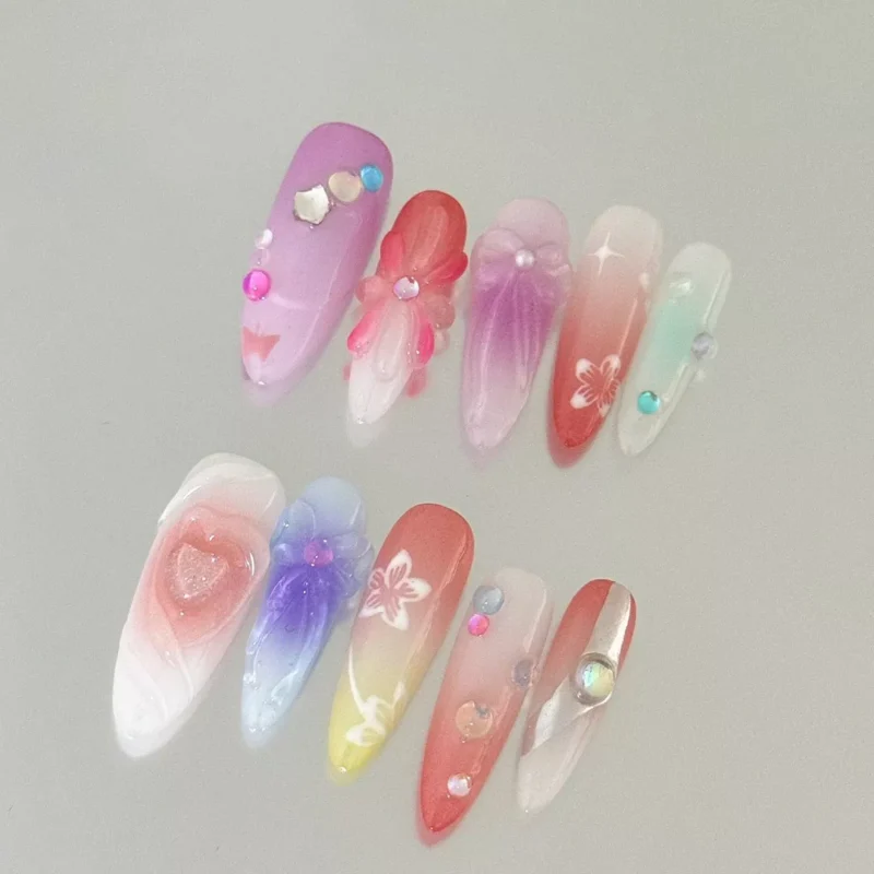 Pastel ombré nails with floral linework and rhinestone details