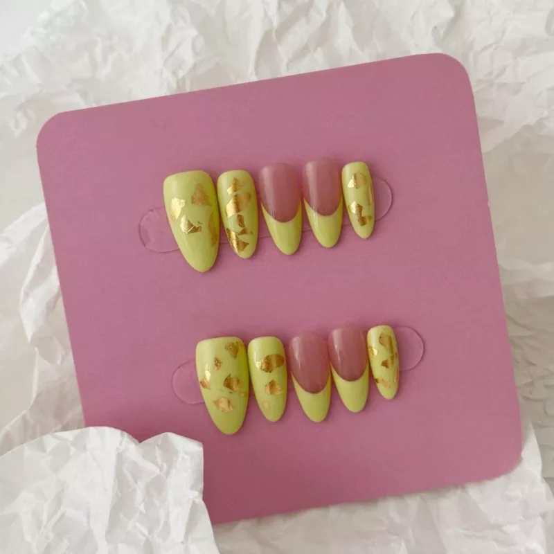 Short almond matte press-on nails with spring green color and taupe accents – lifestyle photo
