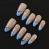 Sheer base starburst press-on nails with blue French tips and multicolor rhinestone accents – top view