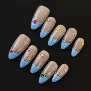 Sheer base starburst press-on nails with blue French tips and multicolor rhinestone accents – top view