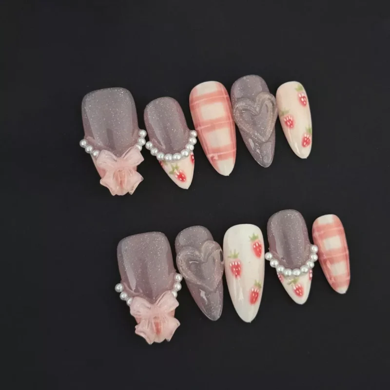 Strawberry Glitter Almond Press-On Nails featuring pink glitter gradient and pearl heart accents