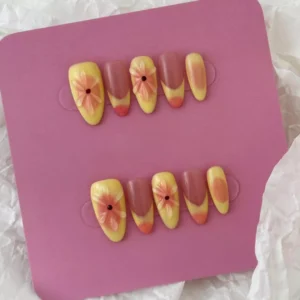 Summer pastel press-on nails with yellow gradient and raised flower design