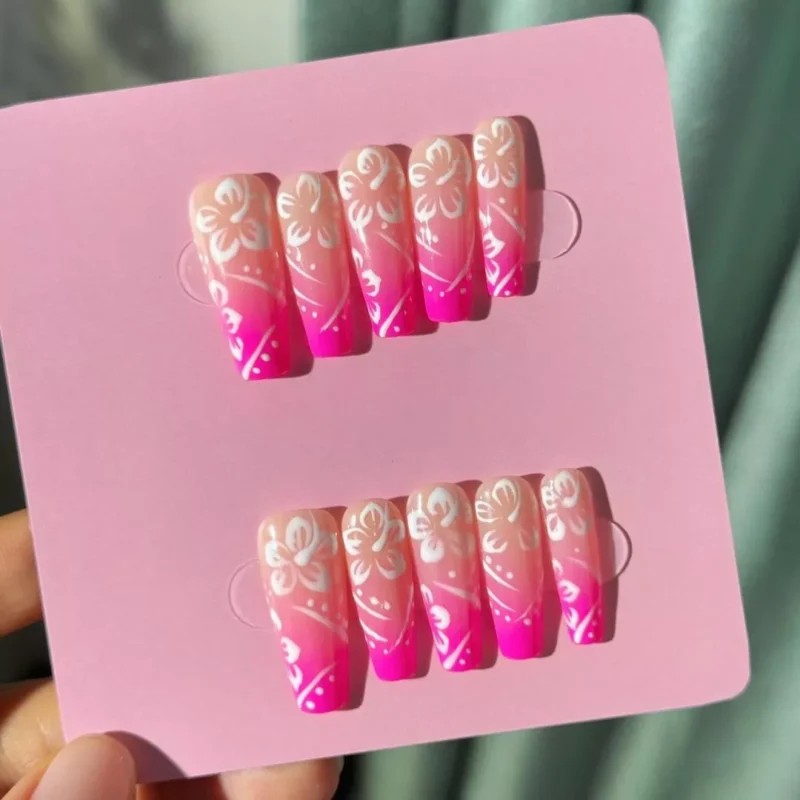 Full nail set of Summer Hibiscus Nails displayed on pink backing card