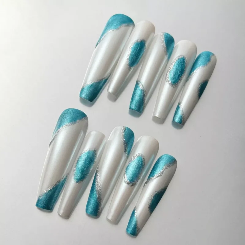 Oval teal chrome press-on nails with pearl base and silver detailing