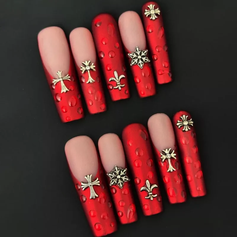 Velvet crimson press-on nails with matte red cross design and 3D droplets