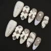 White Bow Press-On Nails - 3D Carved Details with Pearl Accents 13 White Bow Press-On Nails featuring 3D carved details and pearl accents - full hand view