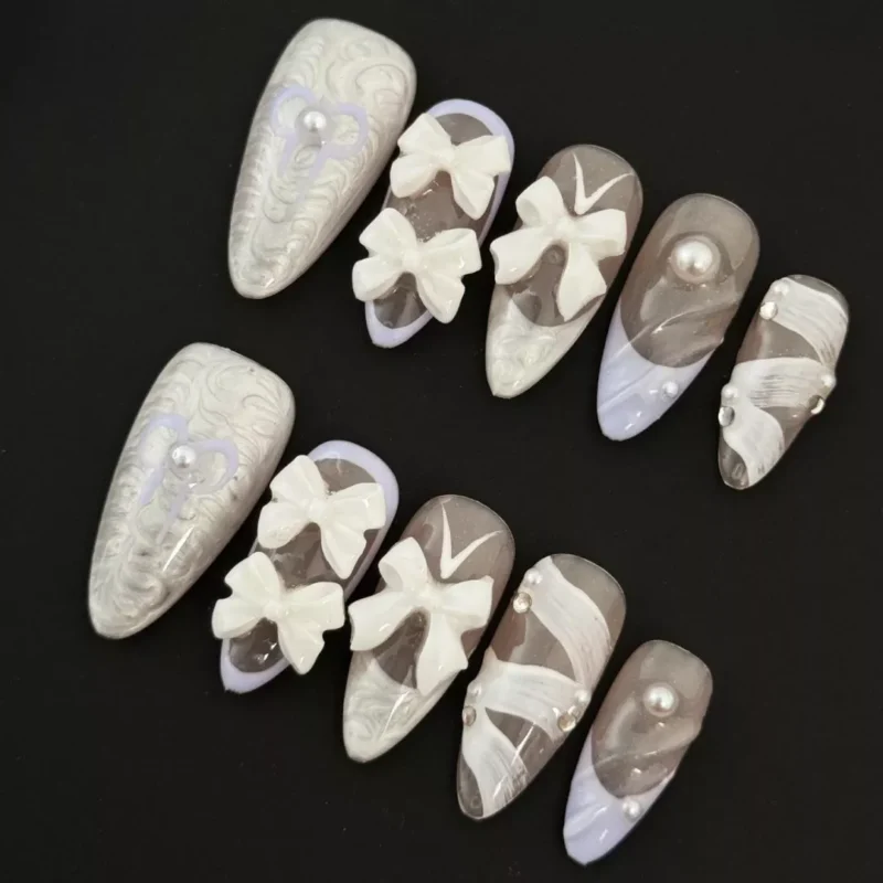 White Bow Press-On Nails featuring 3D carved details and pearl accents - full hand view