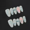 White cartoon press-on nails with blue kitty and pearl accents - full set view
