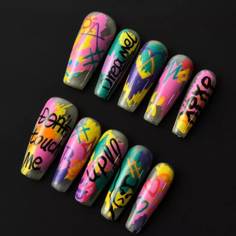 Y2K graffiti press-on nails with neon street art lettering and heart designs – front view
