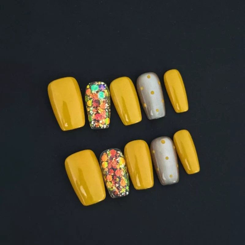 Yellow Glitter Square Press-On Nails with foil accents and polka dots on black background
