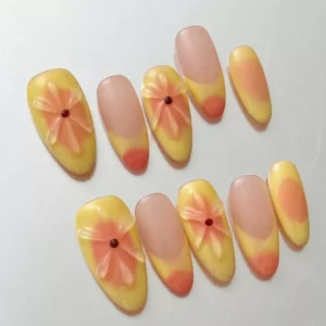 Soft ombre floral press-on nails in yellow with long almond shape