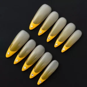 Yellow Tip Ombre Press-On Nails with rhinestone accents on sheer base – angled front view