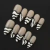 Zebra Stripe Press-On Nails with nude base and graphic wave tips