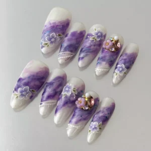 Elegant floral press-on nails in purple with glitter and 3D gem clusters