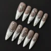 Abstract Silver Line Press-On Nails - Nude & White Base with Rhinestone Accents 6 Abstract silver line press-on nails with nude and white base, shown with rhinestone details in glossy finish – top view
