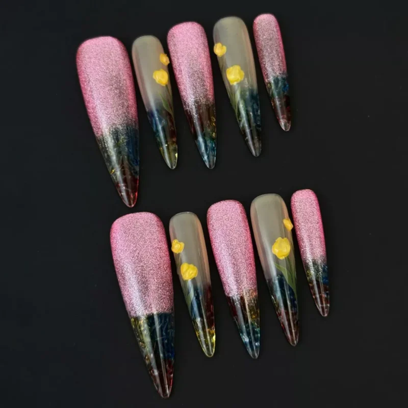 Long almond floral nails with transparent tips and pink glitter gradient