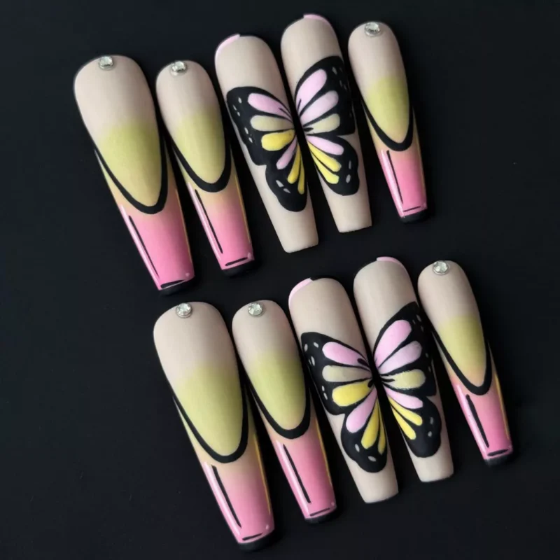 Side view of press-on nails with almond shape and butterfly art