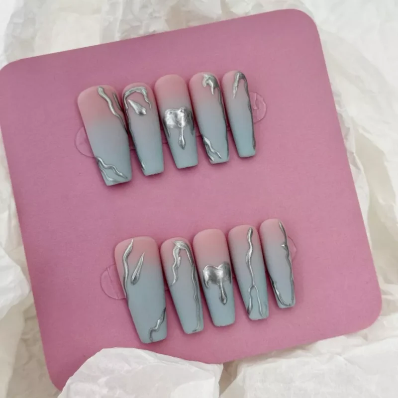 Artistic matte press-on nail set with silver swirl accents and ombre finish