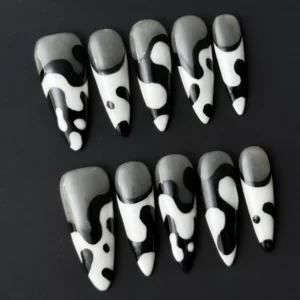 Abstract black and white stiletto nails with flowing ink-style curves