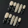 Black Butterfly Press-On Nails with nude base, rhinestones and sleek black line details – top view