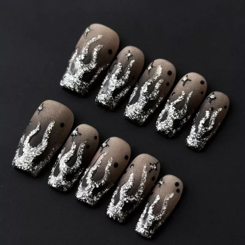 Black silver gradient press-on nails with flame glitter and starry rhinestone accents – front view