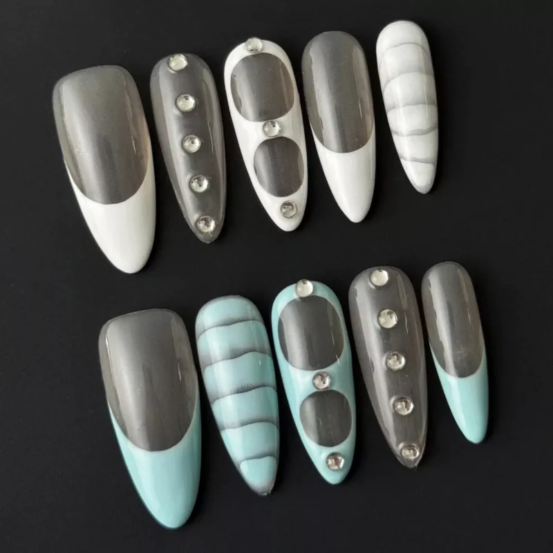 Close-up of Blue Marble Nail Art with soft white overlays and glossy finish