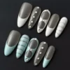 Blue White Marble Press-On Nails with oval shape and glossy gem accents – top angle view