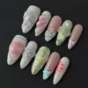 Dreamy Pastel Mixed Press-On Nails - 3D Bows, Iridescent Glitter & Assorted Accents 5 Dreamy pastel mixed press-on nails with 3D bows and iridescent glitter in almond shape – front view