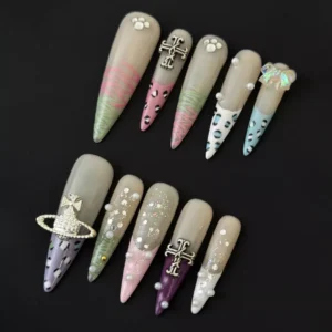 Eclectic mixed press-on nails with leopard print, cross charm, and colorful glitter on sheer base – front view