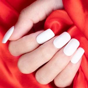 Close-up of hand with glossy white gel polish from blue gray collection