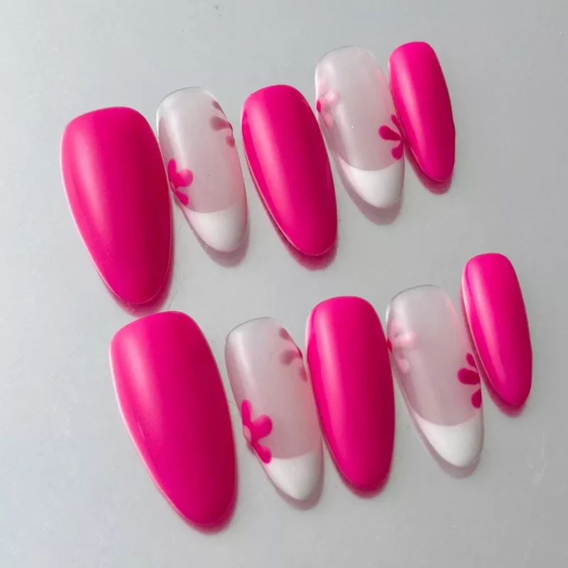 Close-up of floral silhouette nail art on sheer pink press-on nails with almond shape
