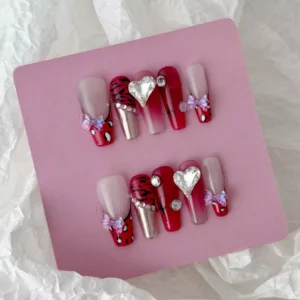 ：Full set of red stiletto chrome press-on nails with gradient finish and decorative accents