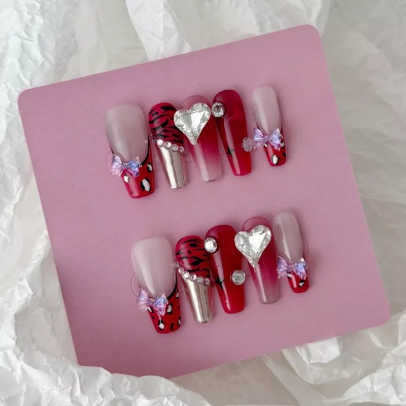 ：Full set of red stiletto chrome press-on nails with gradient finish and decorative accents