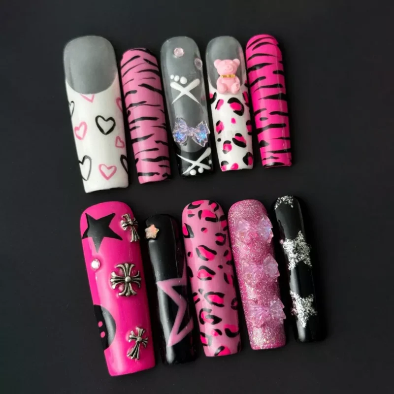 Full set of hot pink Y2K nails in coffin shape with silver and black accents