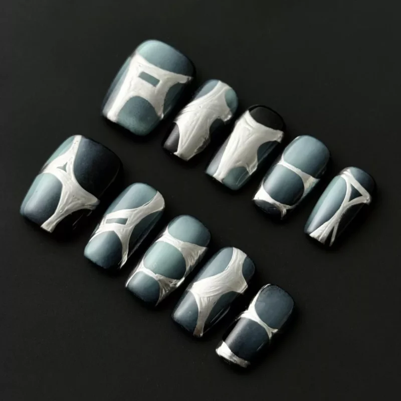 Futuristic chrome press-on nails in gray blue with sculpted abstract accents – front view