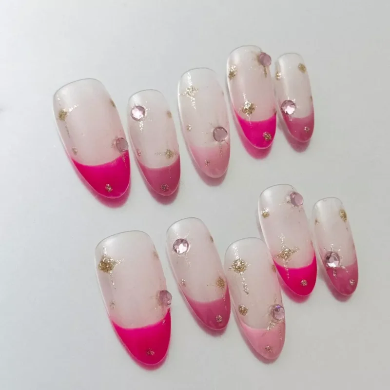 Long coffin press-on nails in nude pink with star accent and glitter tips