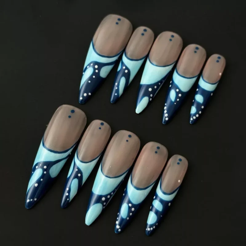 Glossy blue press-on nails with nude base and stiletto dot art – front view