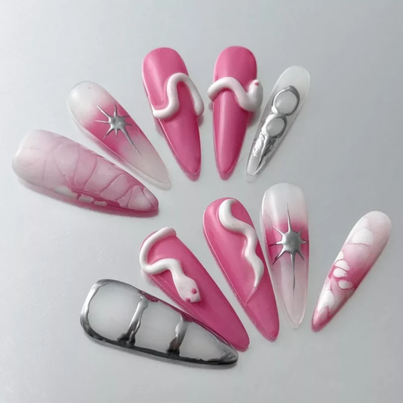 Close-up of stiletto glossy nails with pink gradient and chrome snake pattern
