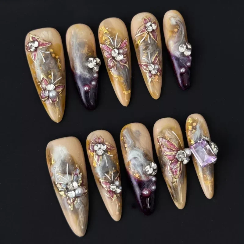 Side view of smoky marble press-on nails with gold flake and gem cluster art