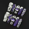 Gothic doodle press-on nails in matte white with purple eyeball and star accents – front view