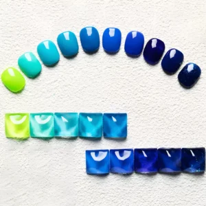 Arched swatch layout of blue gel polish tones from neon to navy