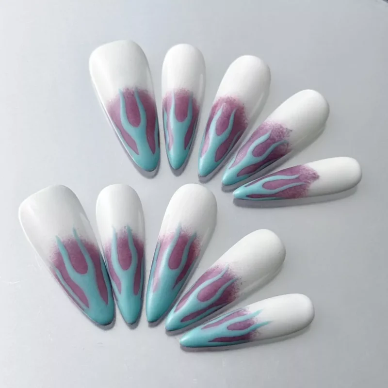 Close-up of glossy gradient ombre flame design on long stiletto press-on nails