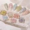 Holographic gel polish swatches on stone with iridescent glitter flakes