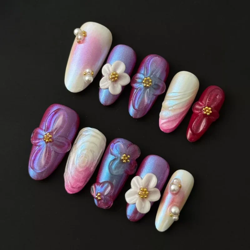 Iridescent 3D floral press-on nails with multicolor shimmer and pearl accents – angled view