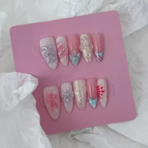 Almond-shaped dreamy pastel nails with iridescent glitter and bow design – top view