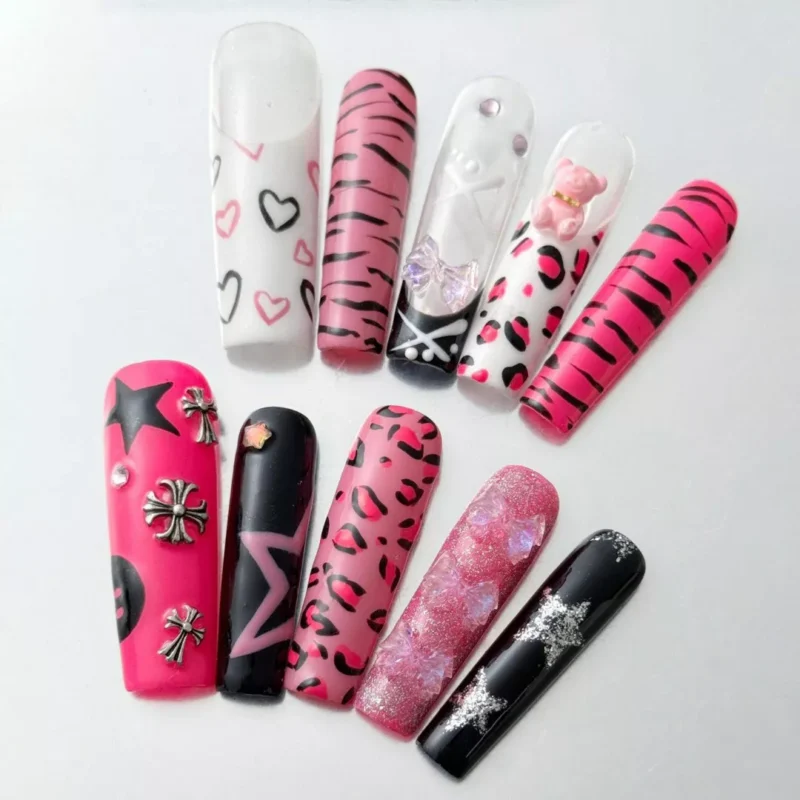 Close-up of pink chrome coffin nails with leopard pattern and shiny star accent
